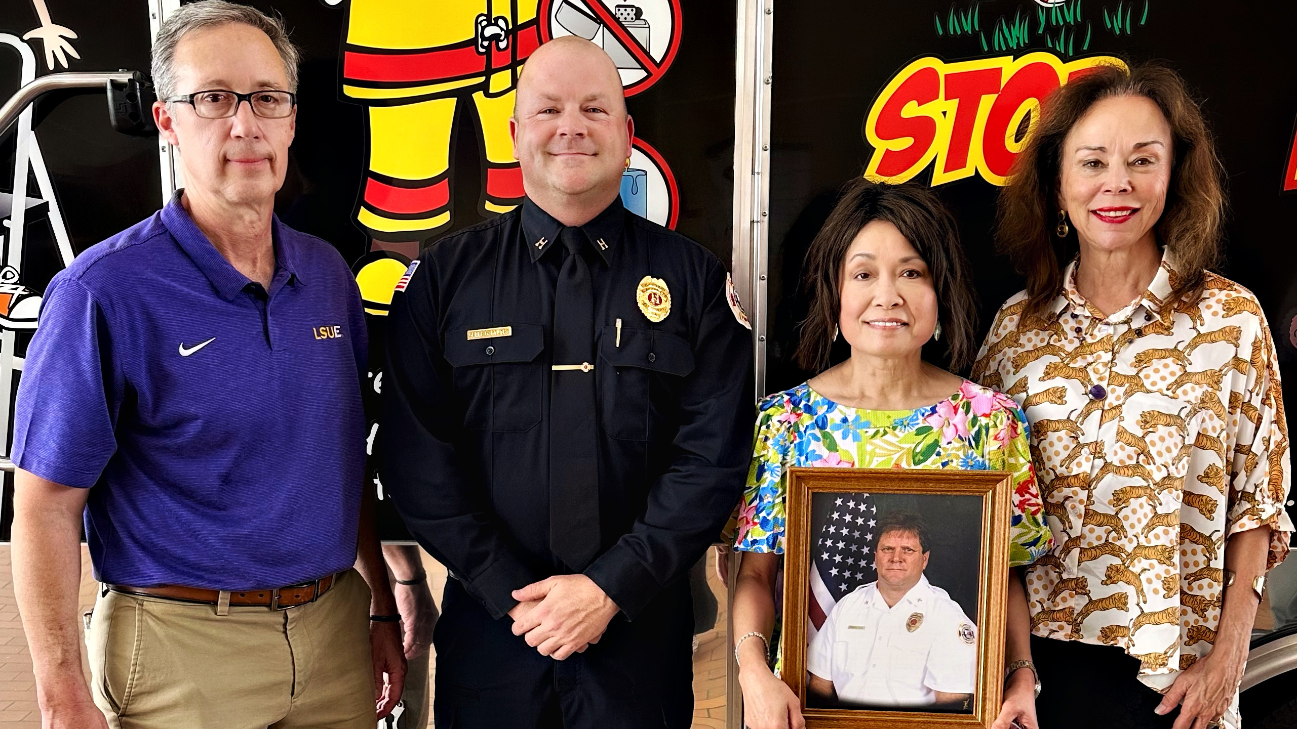 The Terrence "Buster" Ray Gahn Jr. Memorial Scholarship is presented to Fire Captain Clebe alongside LSUE Instructor Rodolphe Toranto, LSUE Chancellor Nancee Sorenson, and the wife of Terrence Gahn, Rose Gahn The Terrence "Buster" Ray Gahn Jr. Memorial Scholarship is presented to Fire Captain Clebe by LSUE Instructor Rodolphe Toranto, LSUE Chancellor Nancee Sorenson, and the wife of Terrence Gahn, Rose Gahn
